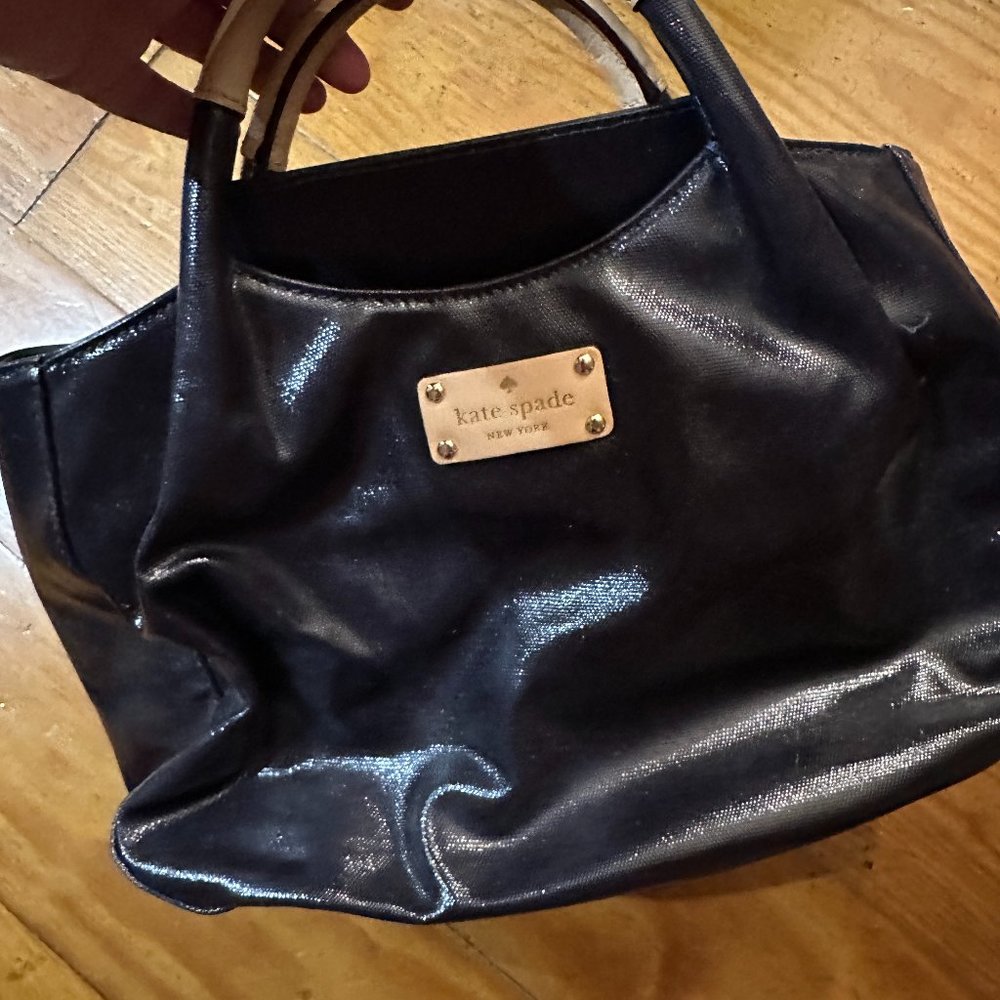 black Kate Spade handbag with polka dot interior
